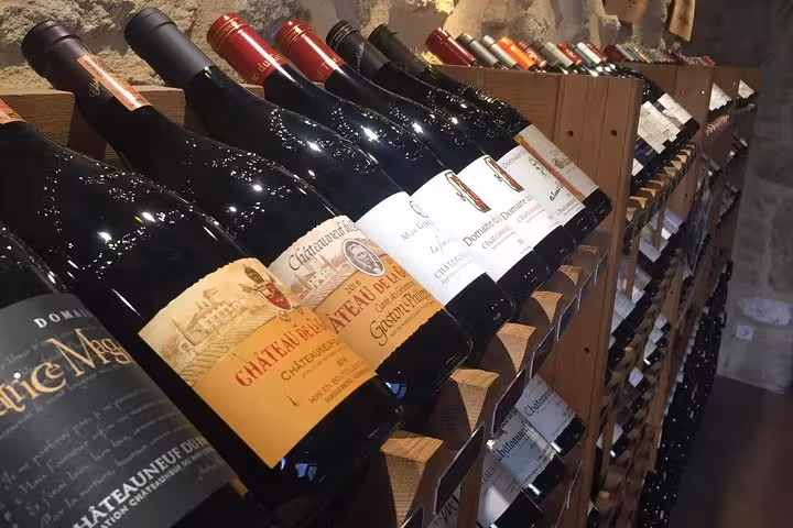Châteauneuf-du-Pape wine bottles in a cellar rack, tasting stop on Avignon Popes Palace wine tour