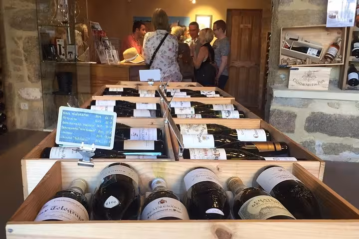 Wine shop tasting room with crates of Châteauneuf-du-Pape bottles on an Avignon Popes Palace tour