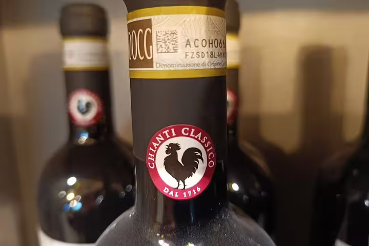 Close-up of Chianti Classico DOCG wine bottles with black rooster seal, featured on Good Morning Chianti Classico winery tour