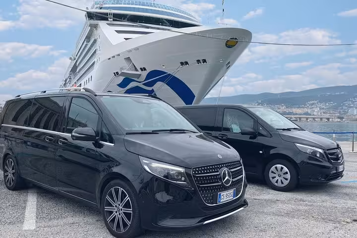 Luxury Mercedes vans parked at Chioggia Port with a cruise ship in the background, ideal for Venice private transfers.