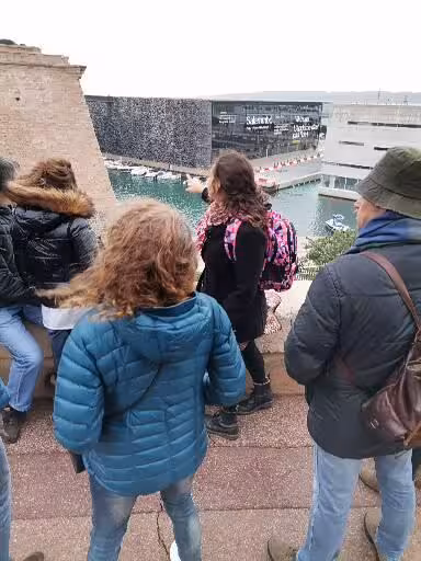 Guided Christian heritage tour group overlooking Marseille MuCEM and harbor, cultural Provence pilgrimage stop