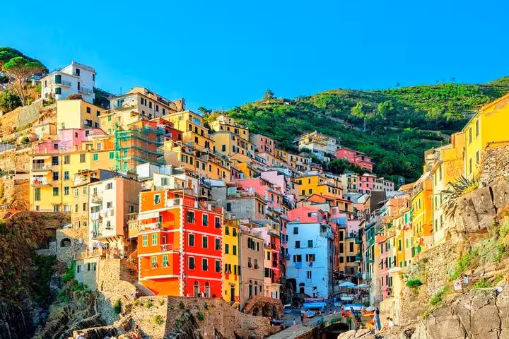 Colorful hillside buildings in Riomaggiore, Cinque Terre, showcasing vibrant architecture on a sunny day.