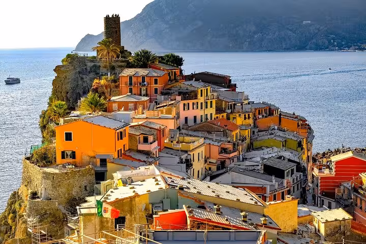 Colorful cliffside houses in Vernazza overlook the sparkling Mediterranean Sea in Cinque Terre, Italy.