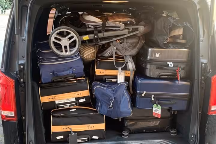 Spacious vehicle trunk loaded with luggage for convenient transfer from Civitavecchia port to Rome or airport.