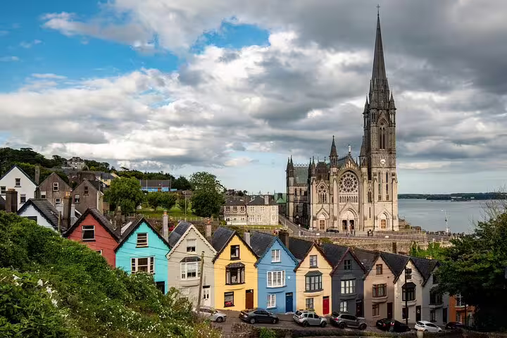 Colorful Cobh waterfront houses and St Colman’s Cathedral, scenic stop on Dublin to Cork day tour