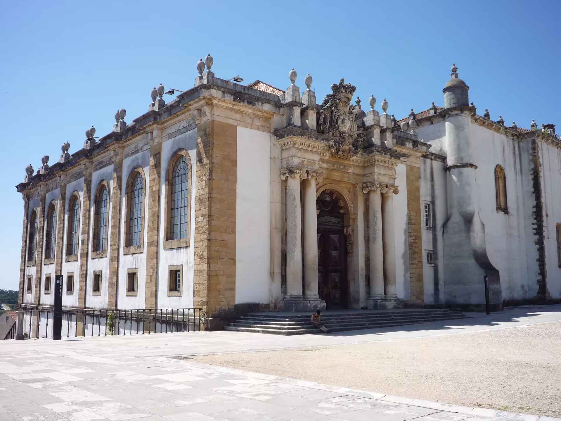 Historic Coimbra University building with ornate architecture on a sunny day, featured in the Coimbra & Aveiro XL tour from Lisbon.