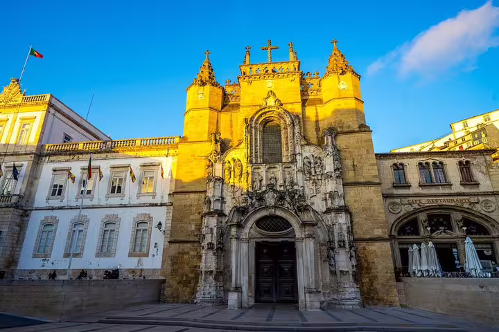 Historic Coimbra University building with ornate architecture under a clear blue sky, featured in Fatima and Coimbra Private Tour.
