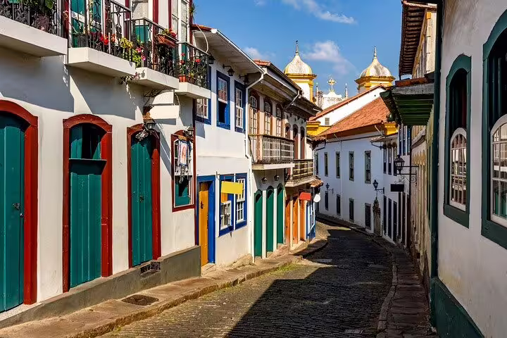 Charming colonial street in Minas Gerais with colorful facades and cobblestone pathways along the Gold Route.