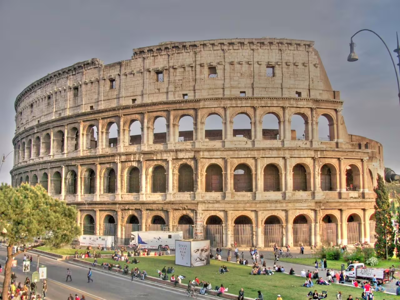 Colosseum exterior in Rome at dusk, iconic landmark on 1.5-hour Ancient Rome sunset golf cart tour