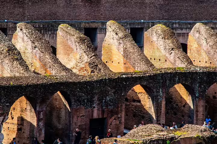 Interior arches and ancient brick corridors of the Colosseum arena in Rome captured on an exclusive private guided tour