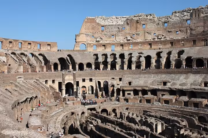 Panoramic interior of the Colosseum displaying historic seating arrangements and structural grandeur.
