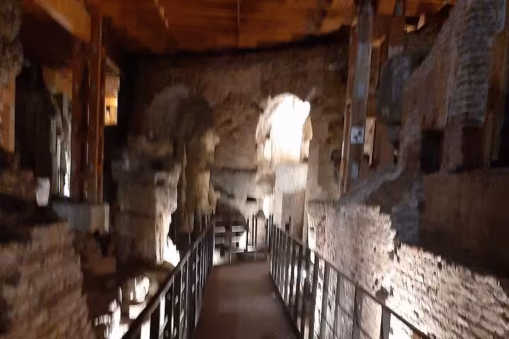 Illuminated historic corridors of the Colosseum offer a unique perspective during a night guided tour in Rome.