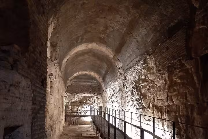Discover the ancient passageways of the Colosseum, beautifully lit for the Rome: Colosseum by Night Guided Tour.