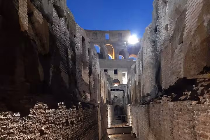 Explore the illuminated corridors of the Colosseum on a Rome by Night Guided Tour, capturing ancient Roman history.
