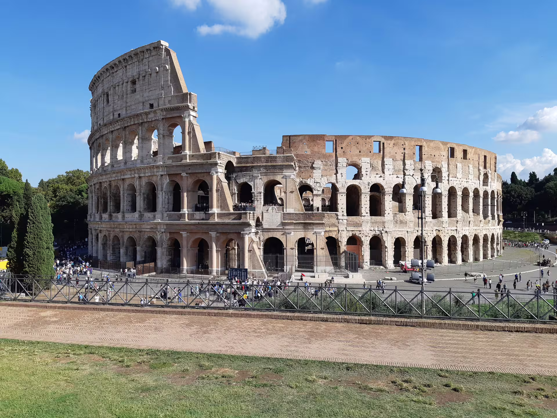 Colosseum view on a sunny day during Welcome Rome semi private walking tour exploring ancient Roman amphitheatre ruins