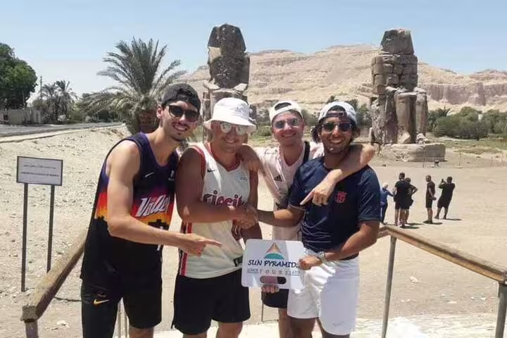 Friends at the Colossi of Memnon viewpoint on a Safaga Port to Luxor private day tour of temples and tombs