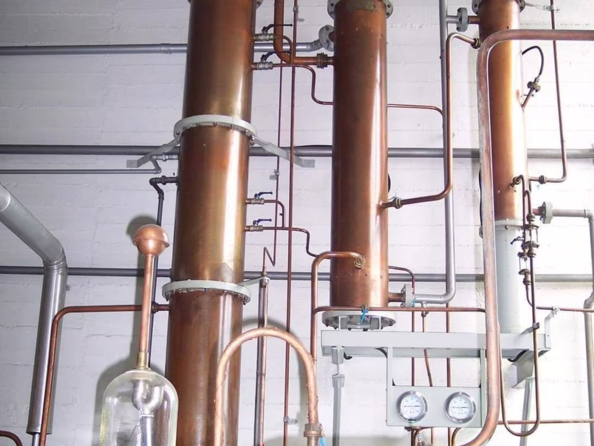 Copper distillation equipment at a Turin distillery, showcasing the intricate process of crafting fine vermouth and spirits.