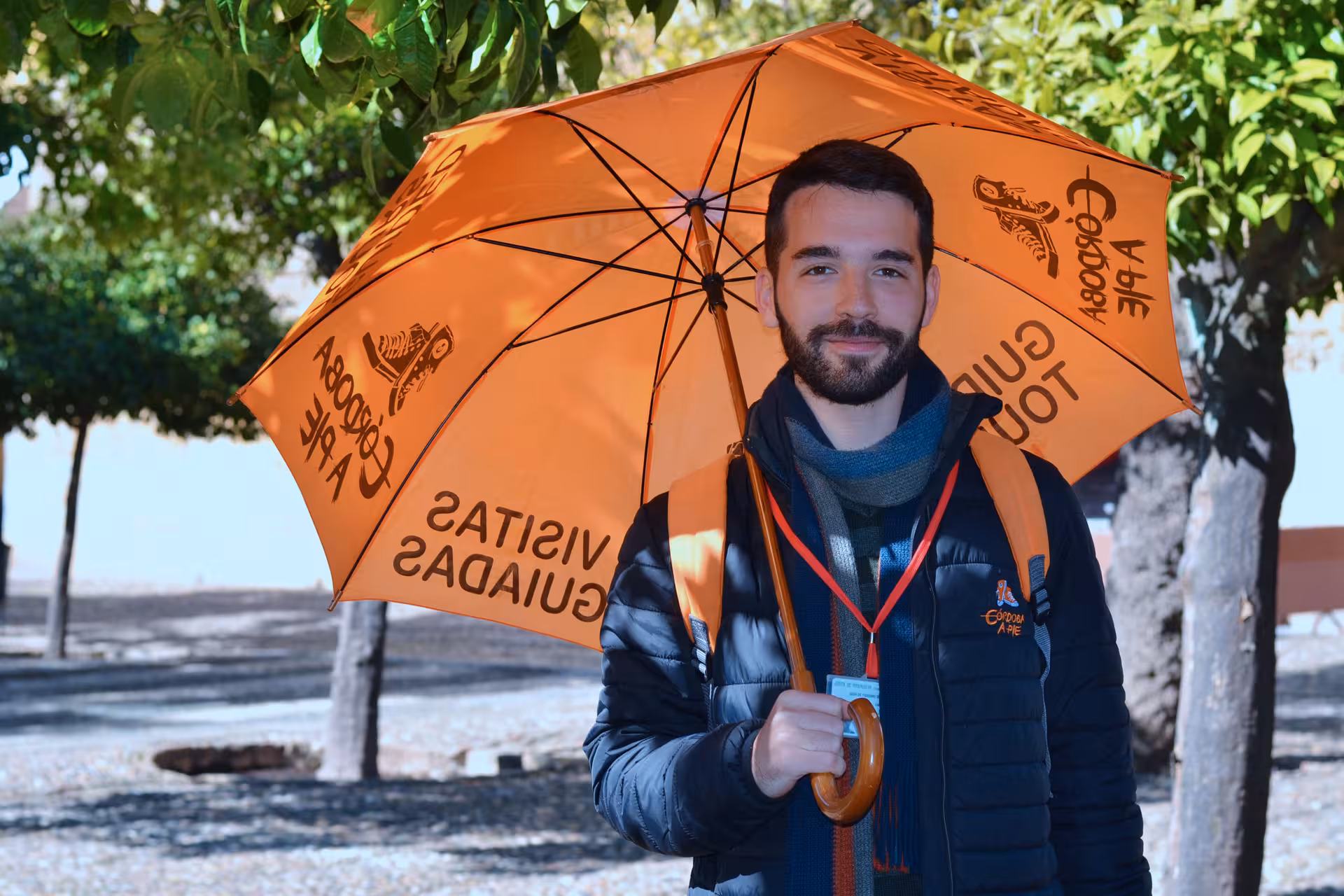 Local guide with orange umbrella in Córdoba, meeting point for free tour and historic walking tour
