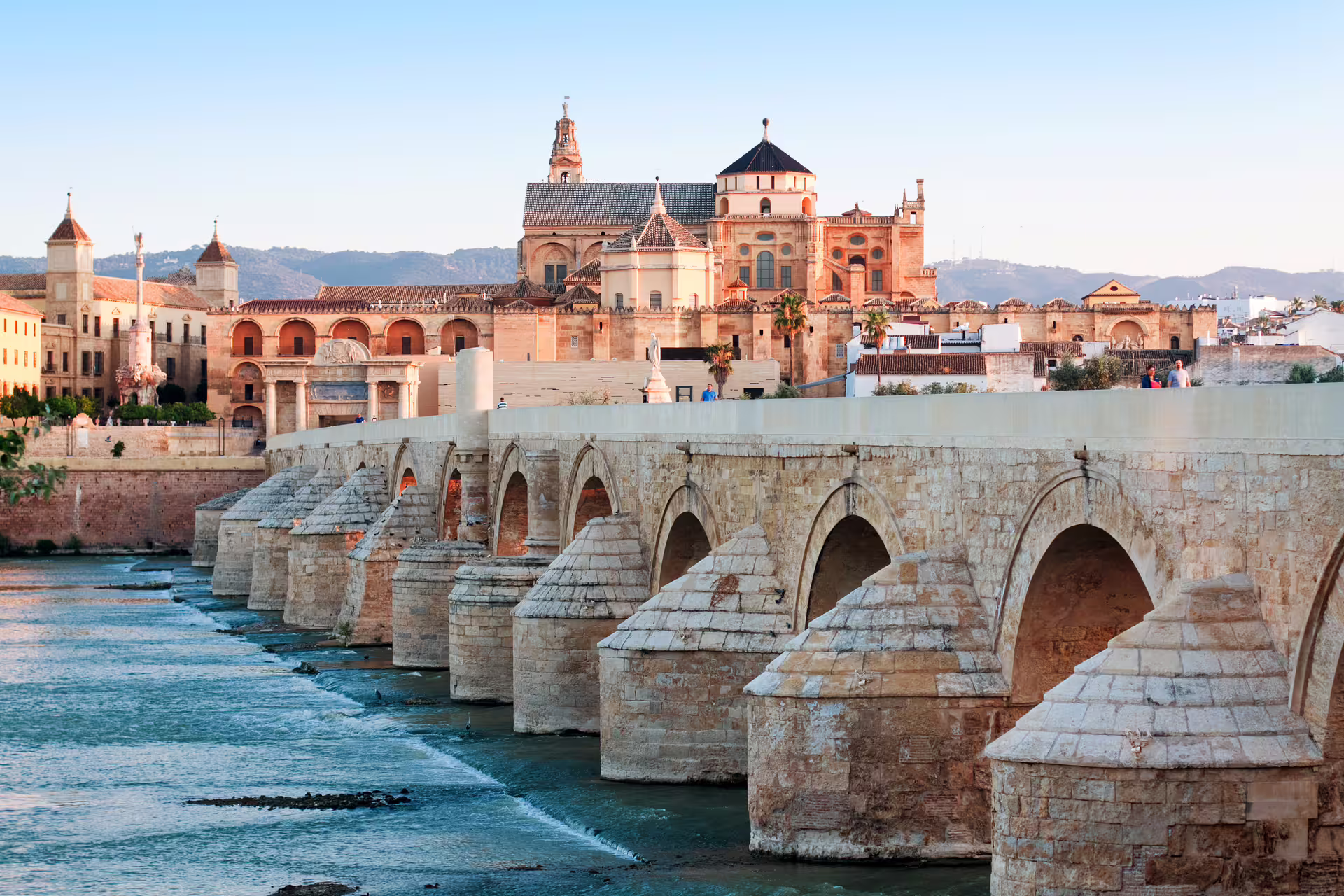 Roman Bridge and Mezquita-Catedral skyline in Cordoba, key stop on 1-day walking tour audioguide