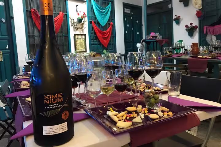 Elegant Cordoba wine and cheese tasting setup with colorful decor and a variety of local wines and cheeses.