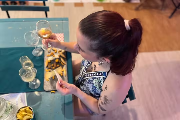 Woman appreciating a glass of local wine paired with cheese in Cordoba, capturing the essence of a sunset tasting tour.