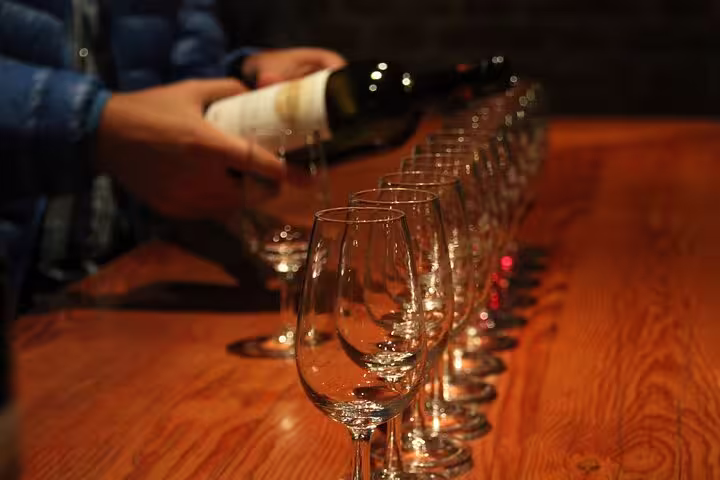 A line of wine glasses awaits pouring during a Cordoba sunset wine tasting event, highlighting local vineyard selections.