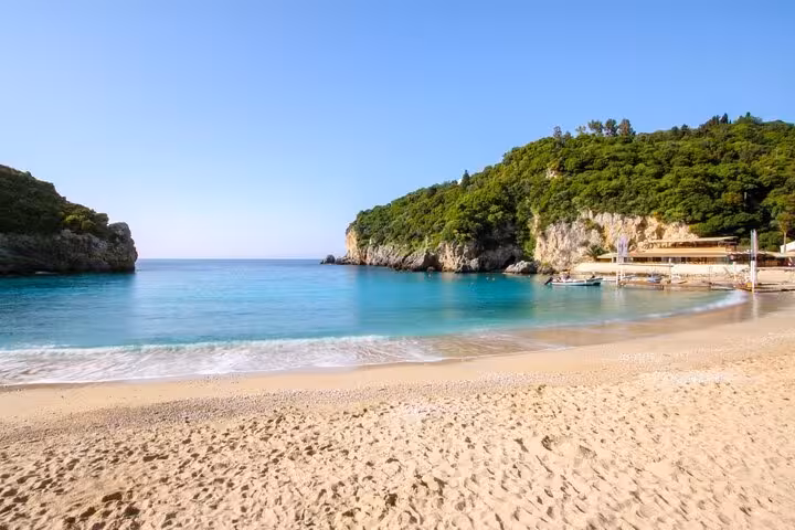 Secluded Corfu beach cove with turquoise water and cliffs, featured on Beauty & the Beach private tour
