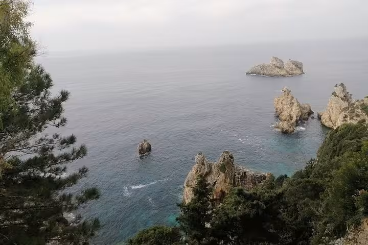 Corfu private beach tour seascape with dramatic Paleokastritsa cliffs, sea stacks and clear Ionian water