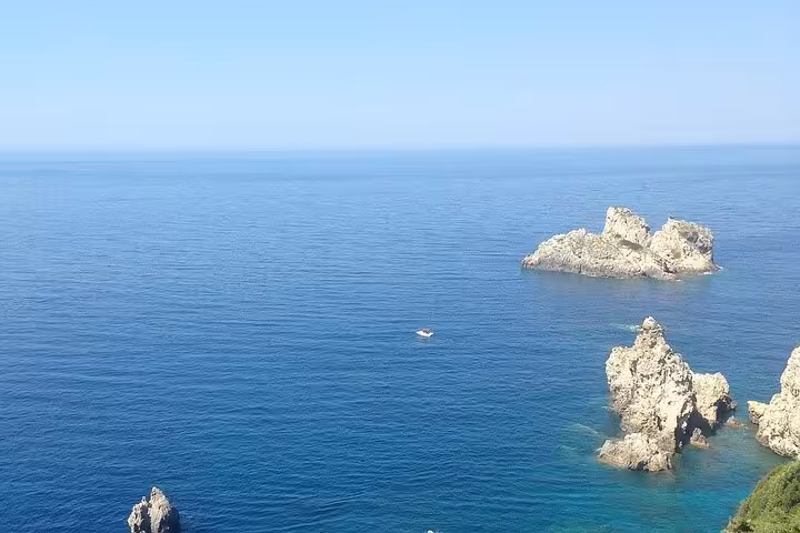 Corfu private shore excursion view of blue Ionian Sea and rocky islets, ideal for guided coastal sightseeing