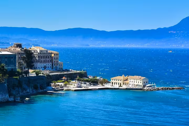 Corfu Town seaside view on a private tour, with Old Fortress waterfront and sparkling Ionian Sea