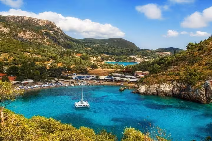 Turquoise bay with sailboat in Corfu on Beauty & the Beach private tour, scenic coastal swim stop