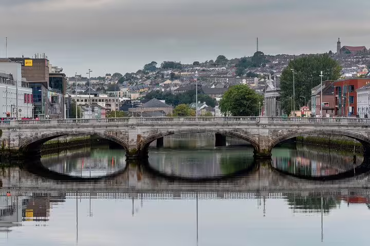 Cork City river bridge and skyline reflected on the Lee, highlight of Dublin to Blarney Castle tour