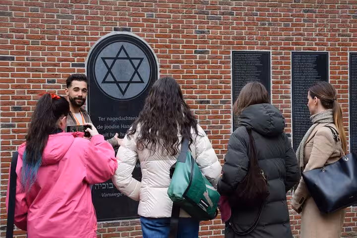 Visitors at Jewish memorial wall in Haarlem on Corrie ten Boom WWII experience, guided small group tour