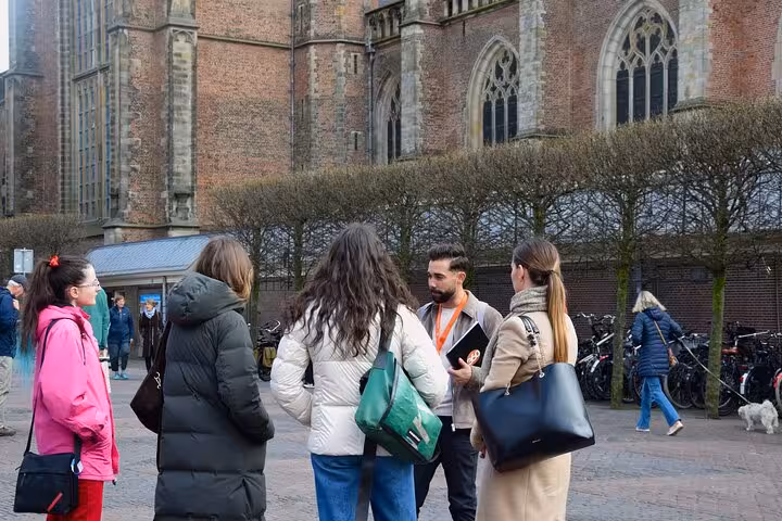 Small group listens to guide outside Haarlem church on Corrie ten Boom and WWII resistance tour