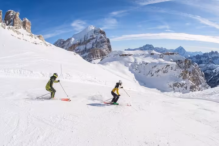 Skiers enjoy the snowy slopes of Cortina d'Ampezzo with scenic mountain views, perfect for winter sports lovers.