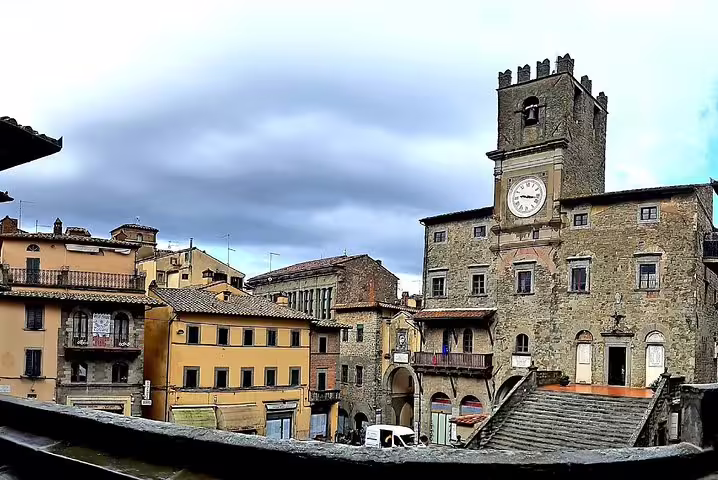 Historic clock tower and medieval stone palazzo in Cortona’s main square, a cultural stop on the private art and wine tour