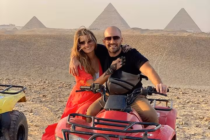 Couple on ATV quad bike with Giza Pyramids backdrop, private desert adventure tour with camel ride and lunch