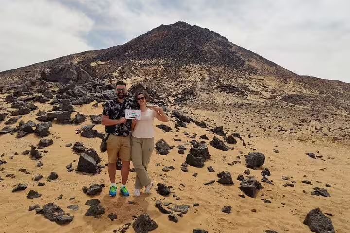 Couple at Black Desert volcanic hill on private 4-day White Desert and Bahariya Oasis tour from Cairo