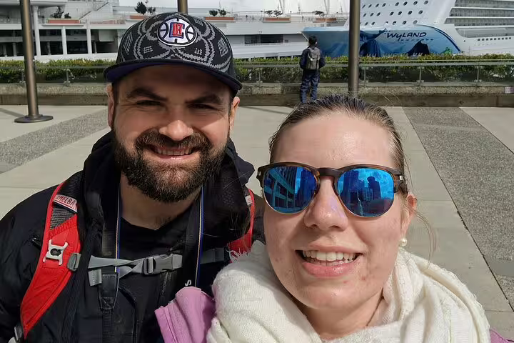 Smiling couple at Canada Place waterfront before Vancouver Gastown scavenger hunt walking tour adventure