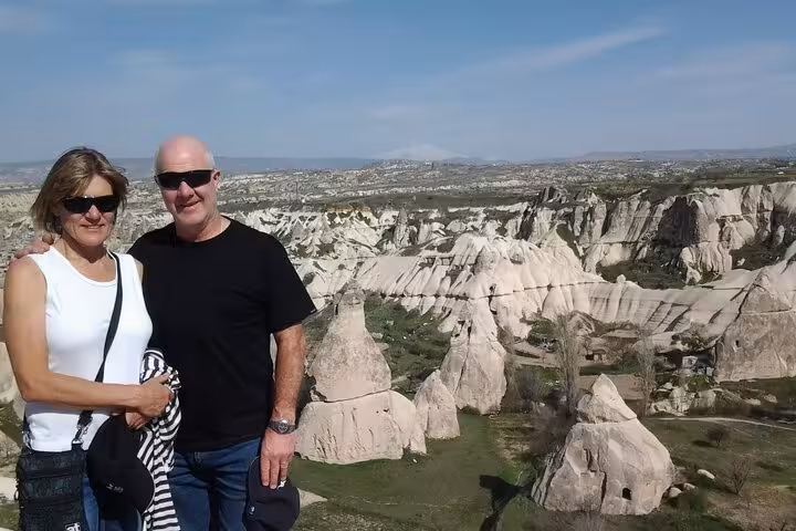 Couple at Cappadocia viewpoint with fairy chimneys and valleys on a private 1-day guided tour with car