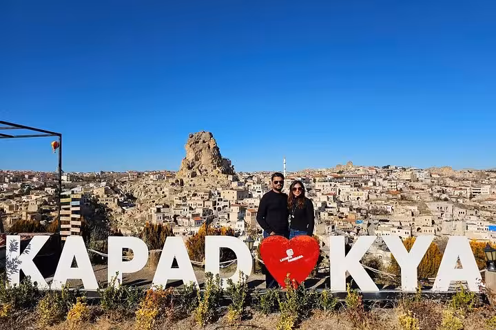 Couple at I Love Cappadocia viewpoint overlooking Uchisar on small group Cappadocia tour with lunch