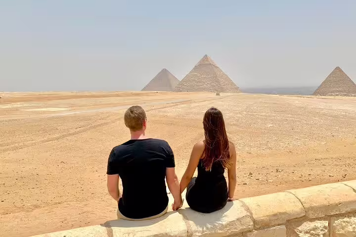 Couple viewing Giza Pyramids on Cairo day trip from Alexandria, returning to Port Said cruise port
