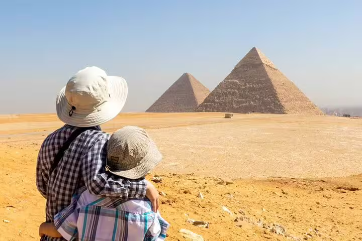 Couple viewing Giza Pyramids on a private guided tour with hotel transfers and entrance tickets included