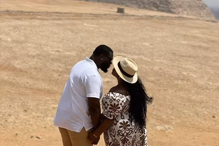 Romantic couple at the Giza Plateau during a private Pyramids and Sphinx tour with ATV ride, camel trek and lunch