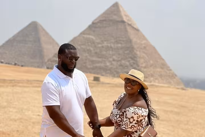 Couple photo at Giza Pyramids on a private Cairo tour with Sphinx visit, ATV quad biking, camel ride and lunch