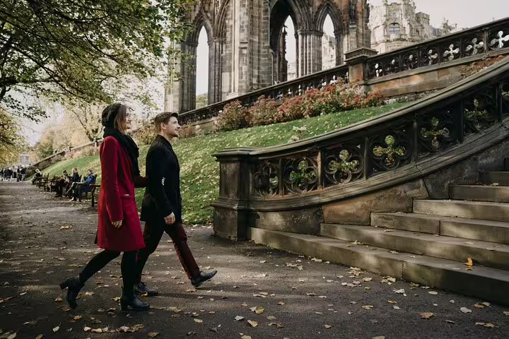 Couple walking by Princes Street Gardens and Scott Monument ruins on private Edinburgh photoshoot tour
