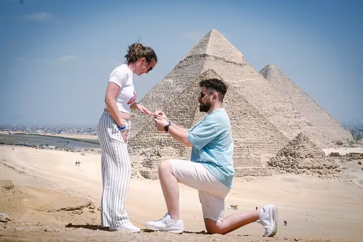 Couple proposal at the Giza Pyramids viewpoint on a half-day private pyramids tour, includes free camel ride