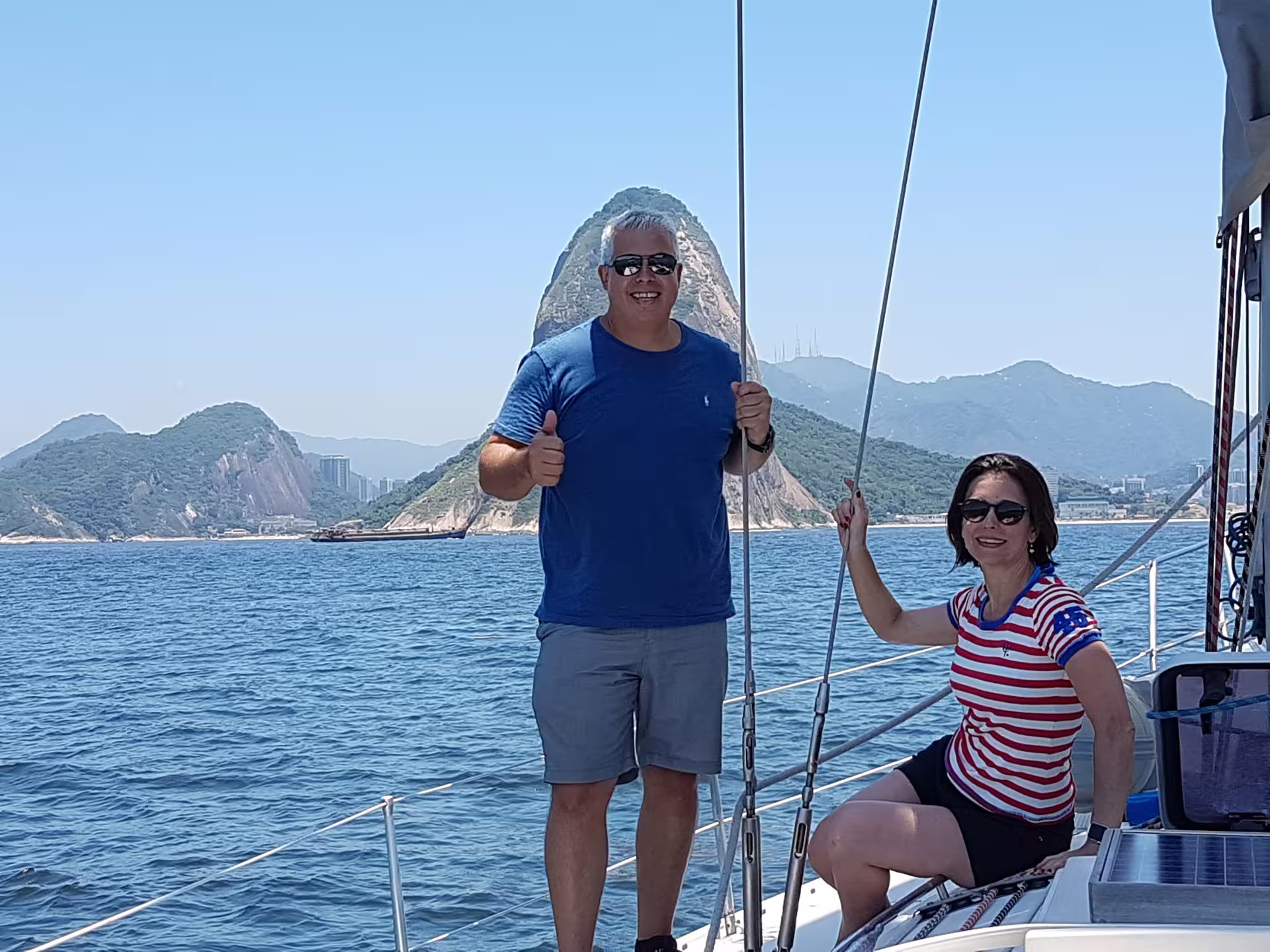 Couple enjoys breathtaking ocean views aboard MAKANI MAIKAI sailing tour, showcasing a perfect day at sea.