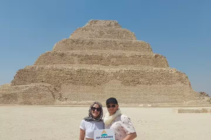 Couple posing at Saqqara Step Pyramid near Cairo, highlight of 2-day Giza and Cairo tour from Alexandria