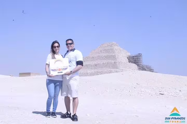 Couple posing by Saqqara Step Pyramid on Giza, Memphis, Dahshur and Saqqara pyramids guided tour from Cairo